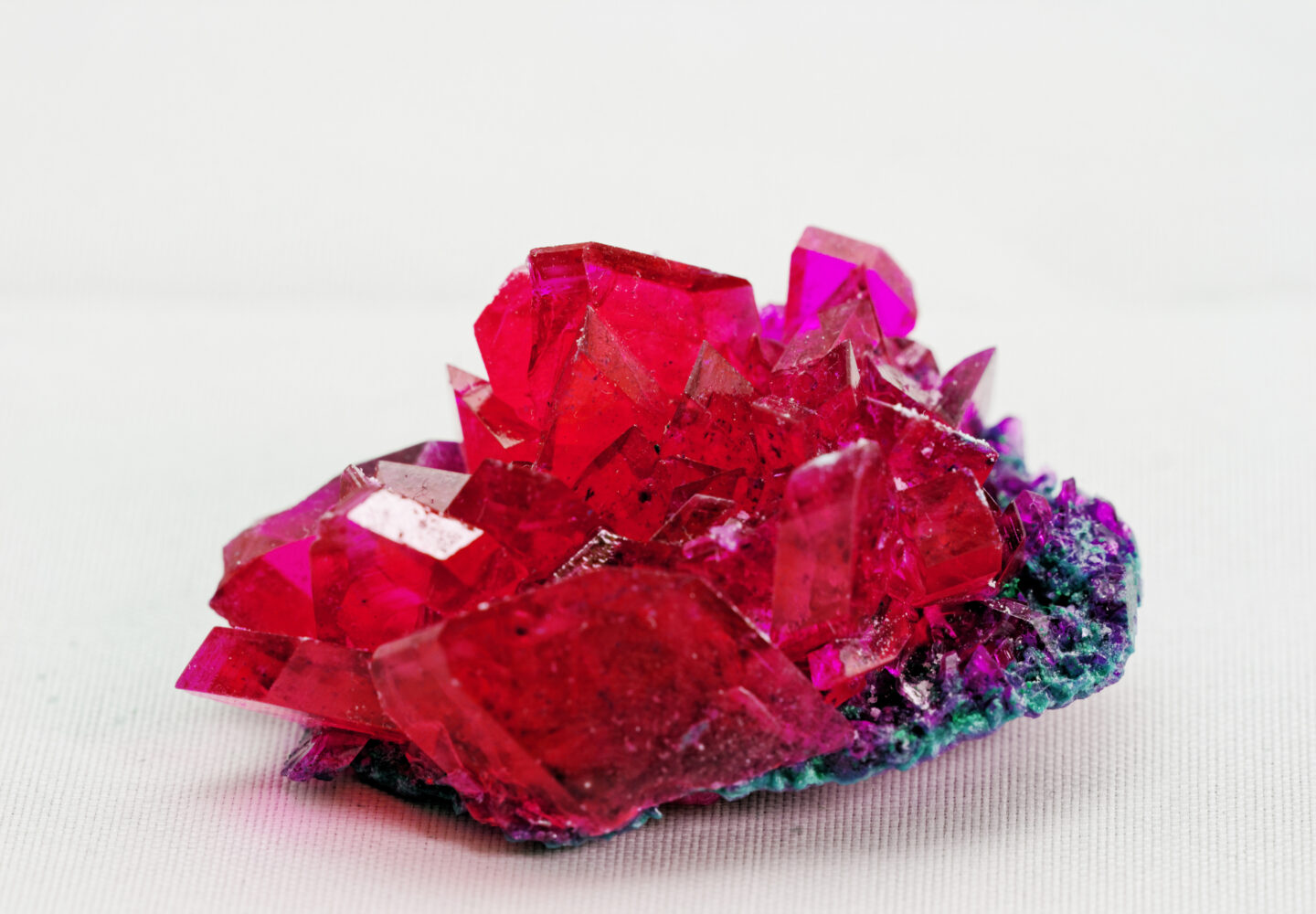 close up of crystals in ruby color on white background (red crystal)