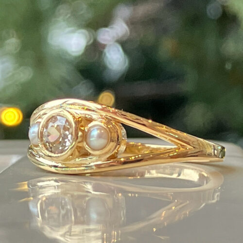 This gorgeous mine cut heirloom diamond has found a new home in this yellow gold custom ring, accented by sweet pearls.  We love preserving our clients' old treasures and helping to bring something into the present, with a whole new story.
