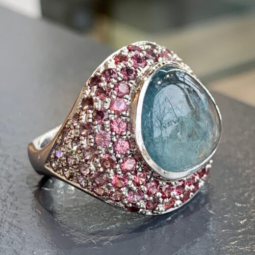 Romeo is one of the most beautiful rings we've ever made, featuring a blue tourmaline and an ombré pavé of pink spinel. 